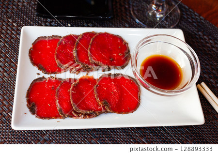 Sliced raw beef fillet Sliced raw beef fillet 128893333