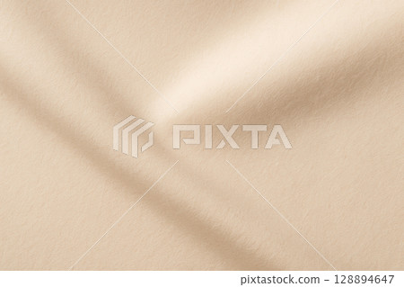 Light filtering through pale beige creased matte paper Light filtering through pale beige creased matte paper 128894647