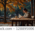 秋季公園長椅上看書的女人 128895006