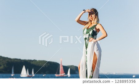 Fashion woman against sea. Fashion woman against sea. 128895356