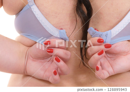Woman wearing bra. Back view Woman wearing bra. Back view 128895943
