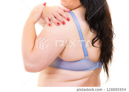Woman wearing bra back view. Strap detail. Woman wearing bra back view. Strap detail. 128895954