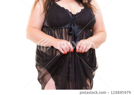 Woman in black lingerie showing her breast chest. 128895979
