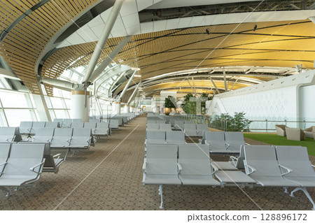 Bangkok, Thailand - April 9,2024 : Interior view of the new SAT-1 terminal in Suvarnabhumi Airport in Bangkok, Thailand on April 9,2024. Bangkok, Thailand - April 9,2024 : Interior view of the new SAT-1 terminal in Suvarnabhumi Airport in Bangkok, Thailand on April 9,2024. 128896172