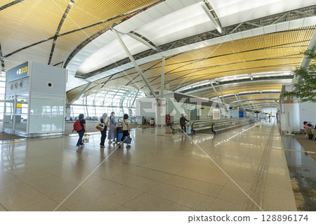 Bangkok, Thailand - April 9,2024 : Interior view of the new SAT-1 terminal in Suvarnabhumi Airport in Bangkok, Thailand on April 9,2024. Bangkok, Thailand - April 9,2024 : Interior view of the new SAT-1 terminal in Suvarnabhumi Airport in Bangkok, Thailand on April 9,2024. 128896174