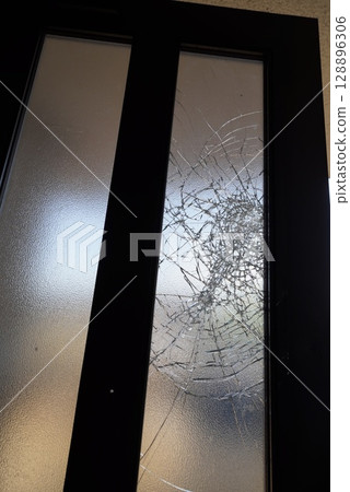 Broken entrance door with broken glass 128896306