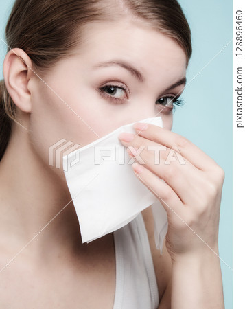 Flu allergy. Sick girl sneezing in tissue. Health 128896460