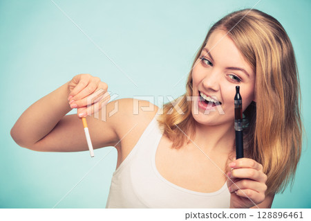 Girl with normal and electronic cigarette. 128896461