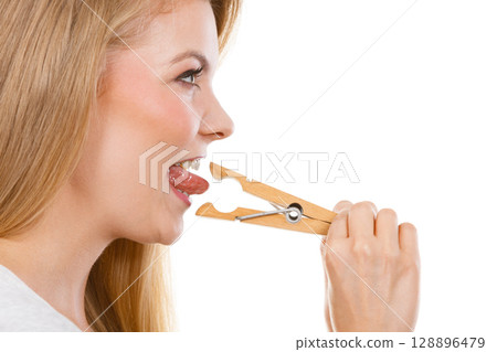 Blonde woman having tongue in clothespin 128896479