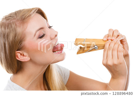 Blonde woman having tongue in clothespin 128896480