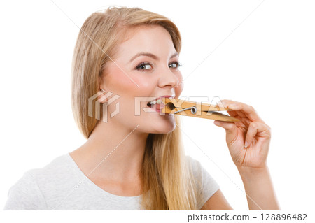 Blonde woman having tongue in clothespin 128896482