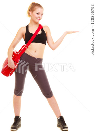 Sport. Fitness girl with gym bag showing copy space 128896798