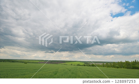 A Beautiful Scenic Cloudy Sky Over Expansive Green Fields Landscape That Is Truly Breathtaking 128897253