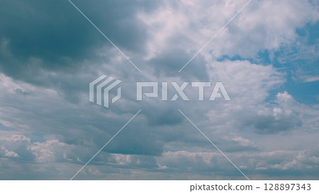 There is a beautiful, cloudy sky overhead that captures the essence of tranquility and calmness There is a beautiful, cloudy sky overhead that captures the essence of tranquility and calmness 128897343