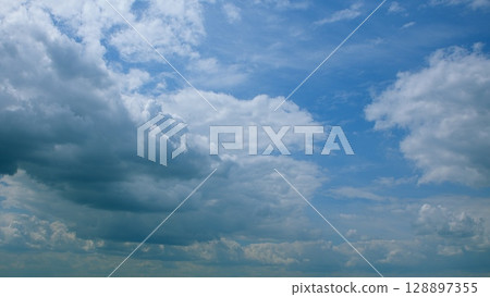 A Serene Sky with Beautiful Cloud Patterns Gracefully Floating Overhead in the Atmosphere A Serene Sky with Beautiful Cloud Patterns Gracefully Floating Overhead in the Atmosphere 128897355