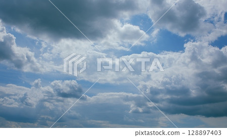 A Majestic Cloudy Sky beautifully adorned with a deep Blue Background overhead, captivating A Majestic Cloudy Sky beautifully adorned with a deep Blue Background overhead, captivating 128897403