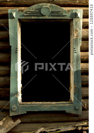 A window with a wooden frame is open and the glass is missing. 128897418