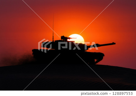 Powerful Silhouette of a Military Tank Against a Fiery Desert Sunset 128897553