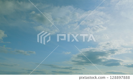 Cumulus Clouds are Suspended Gracefully Above a Beautifully Serene and Calm Blue Sky Cumulus Clouds are Suspended Gracefully Above a Beautifully Serene and Calm Blue Sky 128897888