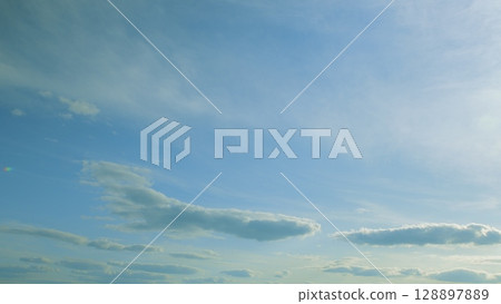 A Beautiful and Serene Sky filled with Soft, Fluffy Clouds Offering Peaceful Atmosphere 128897889
