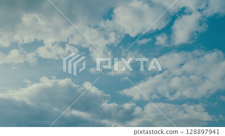 A Beautiful Cloudscape with a Bright Blue Sky creating an enchanting natural atmosphere 128897941