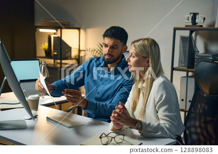 Team Collaboration At Modern Office Discussion On Project Documents Late Evenings 128898083