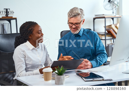 Professional Collaboration Between Two Colleagues in a Modern Office Setting Professional Collaboration Between Two Colleagues in a Modern Office Setting 128898160