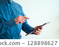 Professional Using Touchscreen Device for Business or Technology Communication Concept 128898627