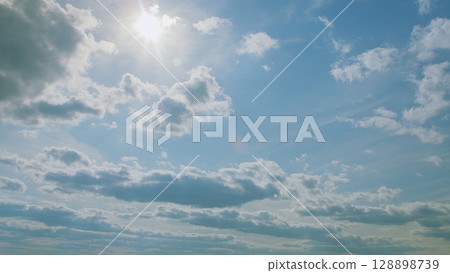 A Beautiful Cloudy Sky that features Radiant Sunlight spilling through the clouds A Beautiful Cloudy Sky that features Radiant Sunlight spilling through the clouds 128898739