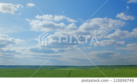 The Serene and Beautiful Sky Over Lush Green Fields is Truly a Stunning Sight to Behold 128898749