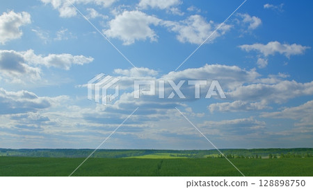Witnessing Breathtaking Landscapes with a Beautiful Blue Sky and Lush Green Fields 128898750
