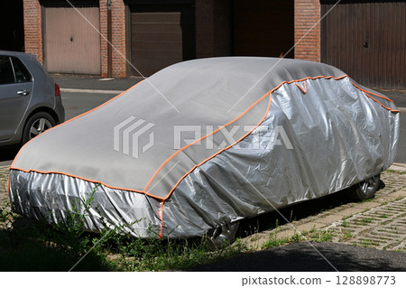 Covered car in the city street 128898773