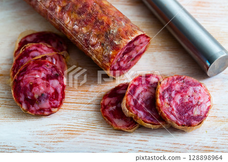 Close-up of spanish salchichon sausage at wooden surface 128898964