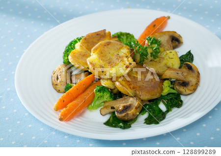Dish of australian cuisine, crash hot potatoes with mushrooms and vegetables 128899289