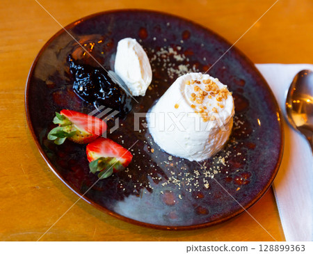 Soft cheese faisselle with strawberry and confiture Soft cheese faisselle with strawberry and confiture 128899363