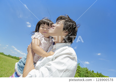 Father and daughter playing in the park Father and daughter playing in the park 128900578
