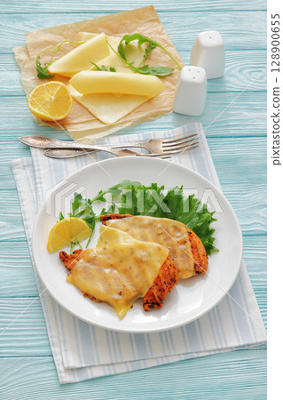 grilled chicken breast topped with melted cheese grilled chicken breast topped with melted cheese 128900655