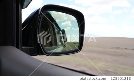 Desert highway reflecting in side view mirror while driving Desert highway reflecting in side view mirror while driving 128901218