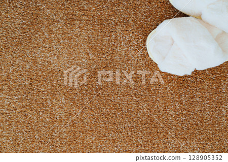 soft white slippers on the beige Interior pile carpet. soft white slippers on the beige Interior pile carpet. 128905352