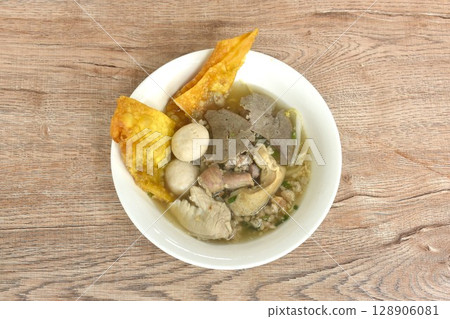 boiled pork ball and entrails with chop pork in clear soup on bowl topping fried crispy yellow dumpling paste 128906081