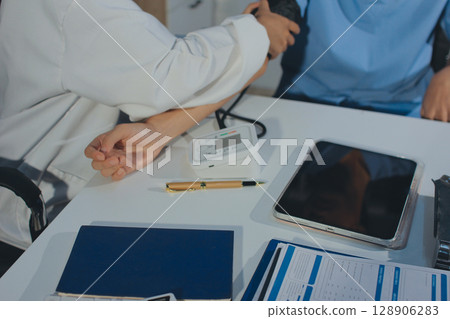 Doctor checking patient arterial blood pressure in hospital. Health care Concept Doctor checking patient arterial blood pressure in hospital. Health care Concept 128906283