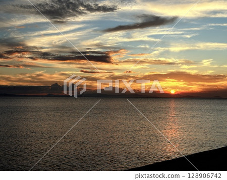 Sunset over the ocean at Matama Beach 128906742