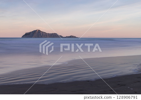 Bear Island and the sunset as seen from Waimarama Beach in the Hastings region of Hawke's Bay, New Zealand 128906791