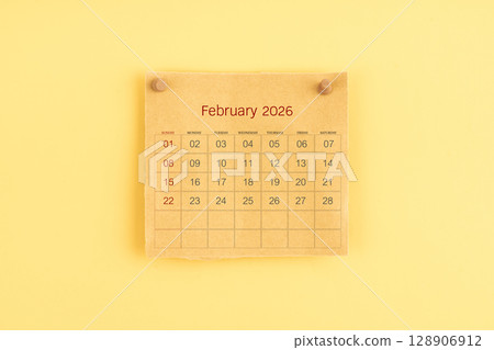 February 2026 brown calendar with wooden thumbtack on yellow color background. 128906912