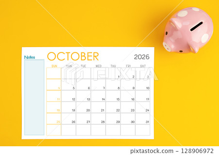 October 2026 calendar and pink piggy bank. Money savings challenge concepts. 128906972