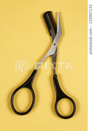 Steel scissors for grooming eyebrows 128907232