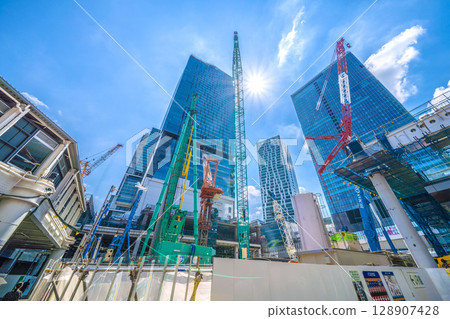 Tokyo cityscape, Japan, July 26th. Extreme heat...huge heavy machinery lined up...goodbye, Shibuya Station West Exit. Full-scale construction begins. 128907428