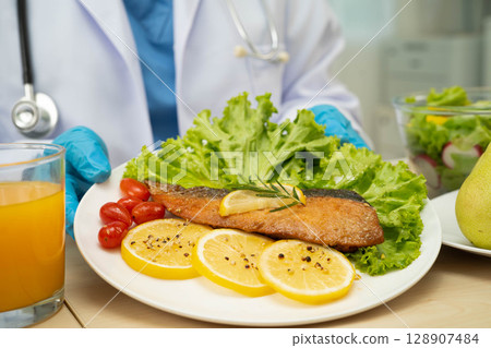 Asian Nutritionist holding healthy food for patient in hospital, nutrition and vitamin. Asian Nutritionist holding healthy food for patient in hospital, nutrition and vitamin. 128907484