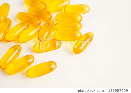 Fish oil or Cod liver oil gel in capsules with omega 3 vitamins, supplementary healthy food. Fish oil or Cod liver oil gel in capsules with omega 3 vitamins, supplementary healthy food. 128907499