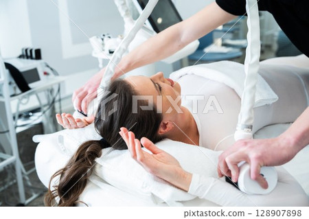 Woman receiving a skincare treatment in a modern beauty clinic Woman receiving a skincare treatment in a modern beauty clinic 128907898